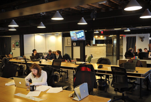 People work at tables inside of the "WeWork" co-operative co-working space on March 13, 2013 in Washington, DC.In a large warehouse-type office in Washington, software coders work on apps, while angel investors and mentors help budding entrepreneurs figure out strategy for their startups, in what is being dubbed Silicon Valley on the Potomac. AFP PHOTO/Mandel NGAN (Photo credit should read MANDEL NGAN/AFP/Getty Images)