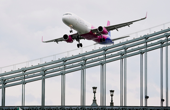A Wizz Air Airbus A321 flies over the oldest Hungarian bridge, the 'Lanchid' (Chain Bridge) of Danube River in Budapest on May 1, 2016 during the Budapest Air Show. / AFP / ATTILA KISBENEDEK (Photo credit should read ATTILA KISBENEDEK/AFP/Getty Images)