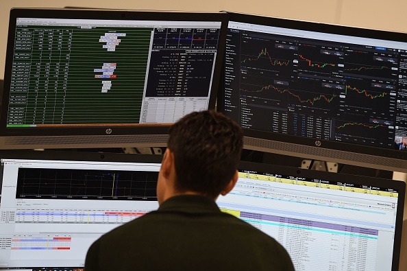 Traders work at the offices of IG markets in Canada on January 16, 2019. - The pound held its ground today and London's FTSE opened higher after the record defeat of British Prime Minister Theresa May's Brexit plan, as investors consider the next developments in the long-running saga. (Photo by Paul ELLIS / AFP) (Photo credit should read PAUL ELLIS/AFP/Getty Images)