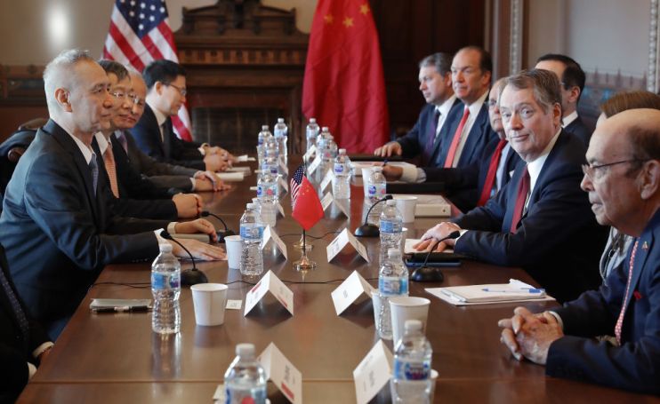 Tumbling Chinese currency drags down stock markets on trade war fears