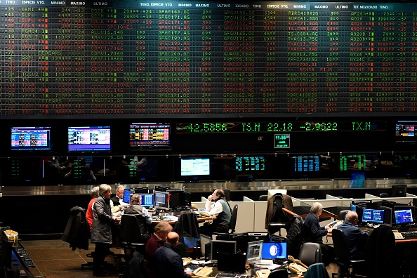 Traders are seen at the Stock Exchange in Buenos Aires on August 12, 2019. - The Buenos Aires stock exchange plunged 10 percent at the start of operations on Monday following liberal President Mauricio Macri's crushing defeat in party primaries over the weekend. Markets reacted with jitters to Macri's massive re-election blow as the peso also went into free fall against the dollar, dropping from 46.55 on Friday to 60. (Photo by RONALDO SCHEMIDT / AFP) (Photo credit should read RONALDO SCHEMIDT/AFP/Getty Images)