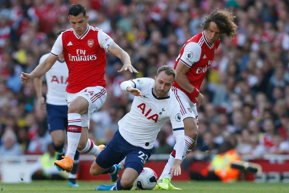 Tottenham Hotspur's Danish midfielder Christian Eriksen (C) vies with Arsenal's Swiss midfielder Granit Xhaka (L) and Arsenal's Brazilian defender David Luiz (R) during the English Premier League football match between Arsenal and Tottenham Hotspur at the Emirates Stadium in London on September 1, 2019. (Photo by Ian KINGTON / IKIMAGES / AFP) / RESTRICTED TO EDITORIAL USE. No use with unauthorized audio, video, data, fixture lists, club/league logos or 'live' services. Online in-match use limited to 45 images, no video emulation. No use in betting, games or single club/league/player publications. (Photo credit should read IAN KINGTON/AFP/Getty Images)