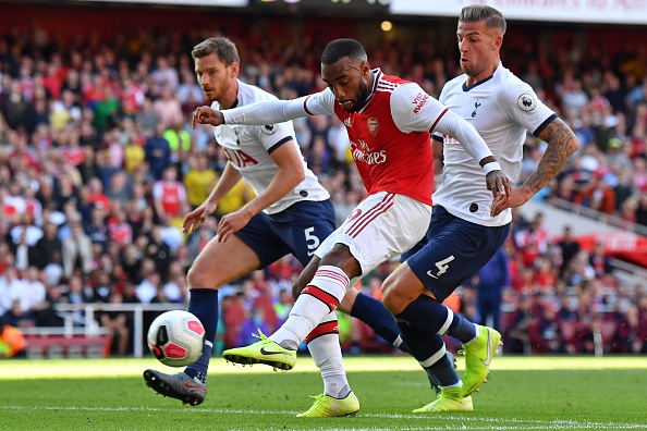 Arsenal's French striker Alexandre Lacazette shoots to score their first goal during the English Premier League football match between Arsenal and Tottenham Hotspur at the Emirates Stadium in London on September 1, 2019. (Photo by Ben STANSALL / AFP) / RESTRICTED TO EDITORIAL USE. No use with unauthorized audio, video, data, fixture lists, club/league logos or 'live' services. Online in-match use limited to 120 images. An additional 40 images may be used in extra time. No video emulation. Social media in-match use limited to 120 images. An additional 40 images may be used in extra time. No use in betting publications, games or single club/league/player publications. / (Photo credit should read BEN STANSALL/AFP/Getty Images)