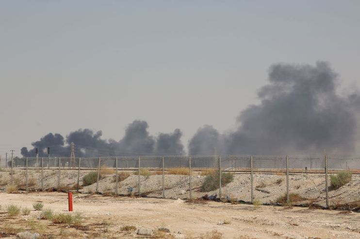 TOPSHOT - Smoke billows from an Aramco oil facility in Abqaiq about 60km (37 miles) southwest of Dhahran in Saudi Arabia's eastern province on September 14, 2019. - Drone attacks sparked fires at two Saudi Aramco oil facilities early today, the interior ministry said, in the latest assault on the state-owned energy giant as it prepares for a much-anticipated stock listing. Yemen's Iran-aligned Huthi rebels claimed the drone attacks, according to the group's Al-Masirah television. (Photo by - / AFP) (Photo credit should read -/AFP/Getty Images)