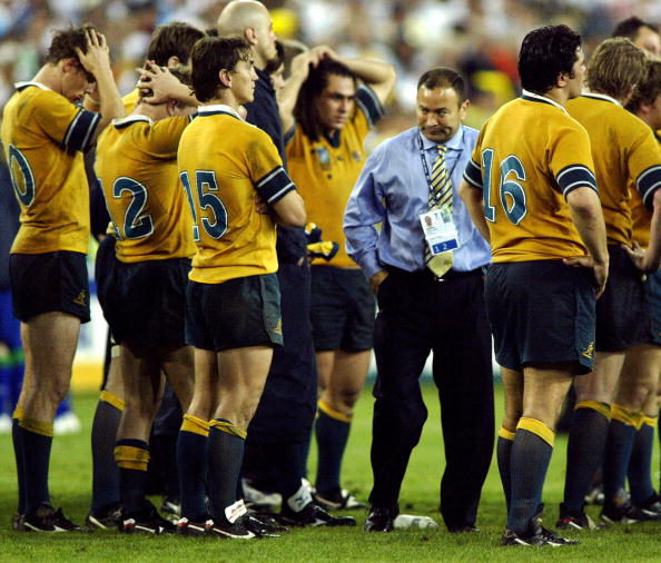 SYDNEY, Australia: Australian coach Eddie Jones (3rdR) reacts with his players after losing the Rugby World Cup final between Australia and England at the Olympic Park Stadium in Sydney, 22 November 2003. England beat Australia 20-17. AFP PHOTO/Peter PARKS (Photo credit should read PETER PARKS/AFP via Getty Images)