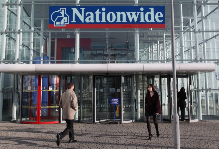 Building society Nationwide&rsquo;s annual profit nearly halved it said today as it warned of rising loan losses due to the coronavirus pandemic.