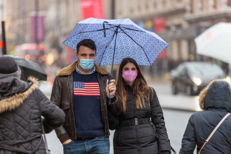 A couple wears face masks as a preventive measure against