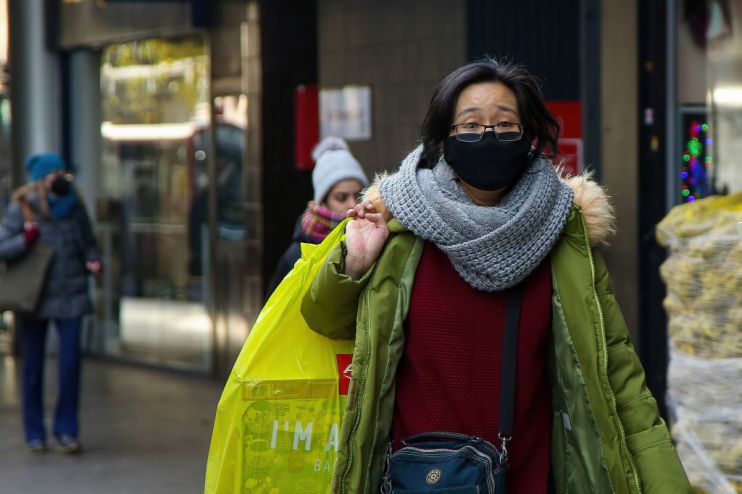 A woman wearing a face mask as a preventive measure against
