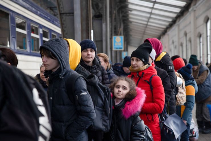 People are waiting in line to board on the train to Poland