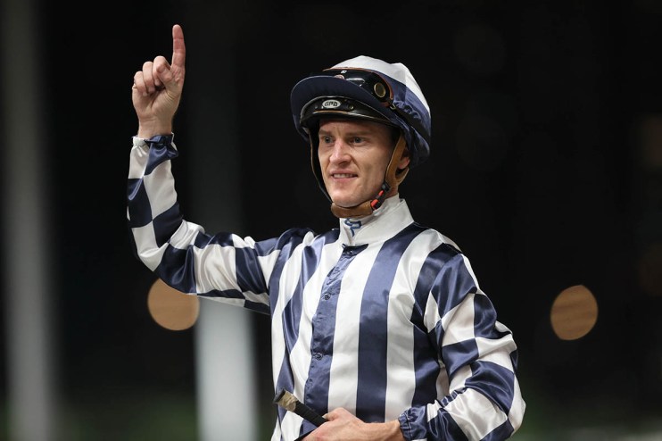 Zac Purton riding in national colors at Happy Valley during the eight-runner race symbolizing World Cup quarter-finalists.