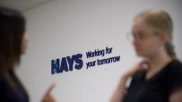 Hays office building with fluctuating stock graph overlay, representing the impact of selling operations in six countries