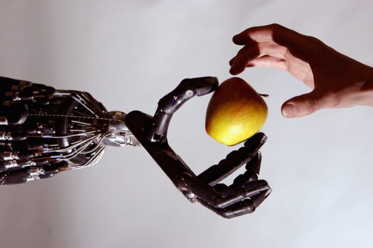 LONDON - MAY 06: The Shadow Robot company's dextrous hand robot holds an Apple at the Streetwise Robots event held at the Science Museum's Dana Centre on May 6, 2008 in London, England. The Dextrous Robotic Hand has a bank of 40 Air Muscles which make it capable of 24 movements and the most advanced robot hand in the World. (Photo by Jeff J Mitchell/Getty Images)