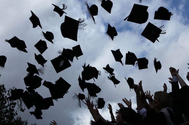 University graduates throw their mortarboards in the air (Photo by Christopher Furlong/Getty Images)
