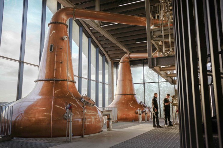 Distillery workers take the cut at the spirit safe at port ellen distillery collecting whisky from the stills after 40 years of closure