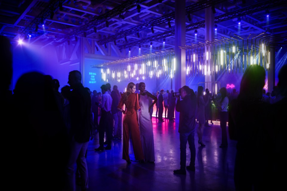 Elegant cocktail party at Olympia West venue featuring guests mingling with drinks in hand, capturing a lively social ambi...