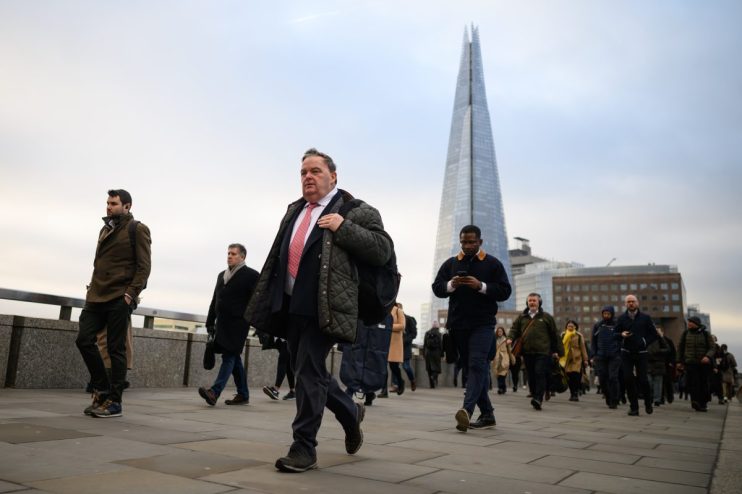 LONDON, UNITED KINGDOM - JANUARY 31: The Shard is seen on the horizon as commuters cross London Bridge during the morning rush hour on January 31, 2023 in London, United Kingdom. The IMF reports that the UK economy will contract by 0.6% in 2023, as opposed to the previous prediction it might grow, and will perform worse than many other advanced economies, including Russia.The cost of living continues to hit households with grocery inflation for the first four weeks of 2023 rising to 16.7% which would add a further &pound;788 per year to family food bills. (Photo by Leon Neal/Getty Images)