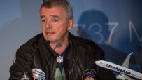 Michael OLeary speaking at a Ryanair press conference, dressed in a suit, discussing the airlines latest business updates