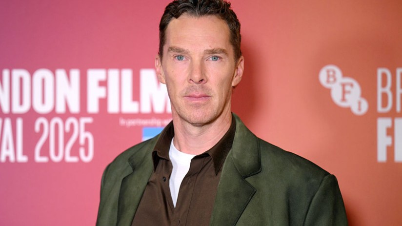 Benedict Cumberbatch attending a red carpet event, wearing a tailored suit and posing for photographers amidst a crowd.