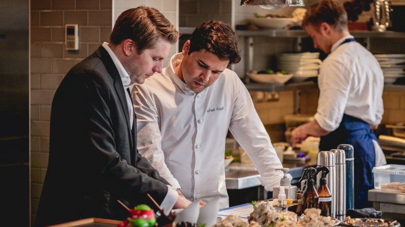 Justin DeSouza at DaTerra showcasing sustainable practices in a vibrant restaurant setting