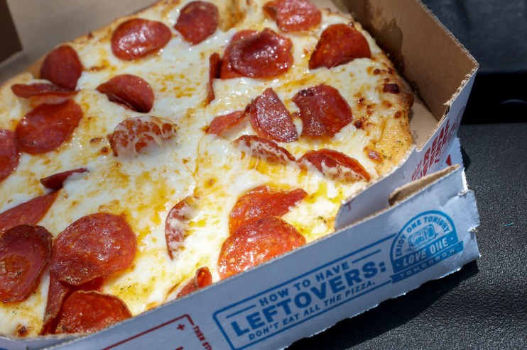 Delicious junk food pizza with melted cheese, pepperoni, and colorful toppings, capturing the essence of indulgent comfort...