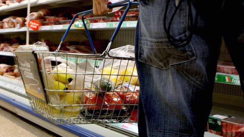 Basket filled with assorted fresh produce and gourmet foods, emphasizing a diverse selection for healthy living
