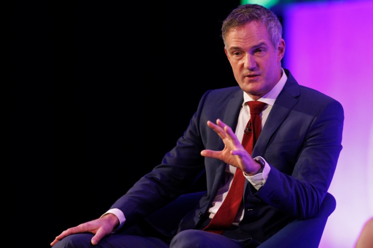 Peter Kyle speaking at a podium during a press conference, addressing current issues and developments