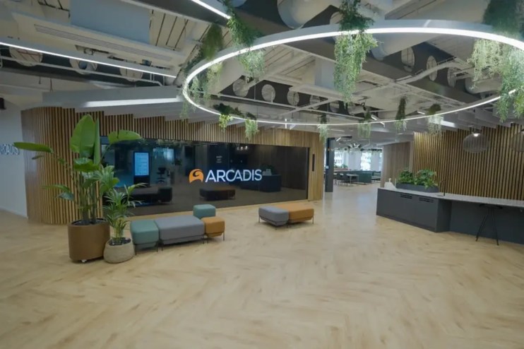 Arcadis office building exterior with company logo, modern architecture against a clear blue sky, reflecting corporate pre...