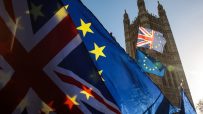 UK-EU Brexit negotiations meeting with officials discussing trade agreements and policy impacts in a formal conference room