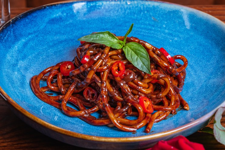 Chocolate spaghetti dish creatively presented on a plate, showcasing a unique culinary fusion for a gourmet dining experie...