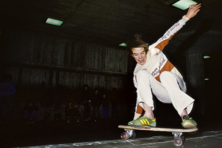 Skateboarding enthusiast performing a trick on a vibrant city street, showcasing urban culture and dynamic movement
