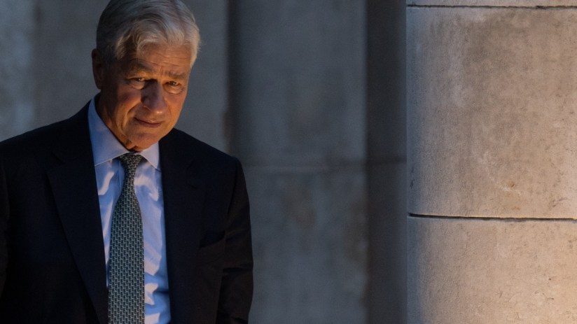 Jamie Dimon in a dark suit, serious expression, business setting, highlighting leadership in the financial industry