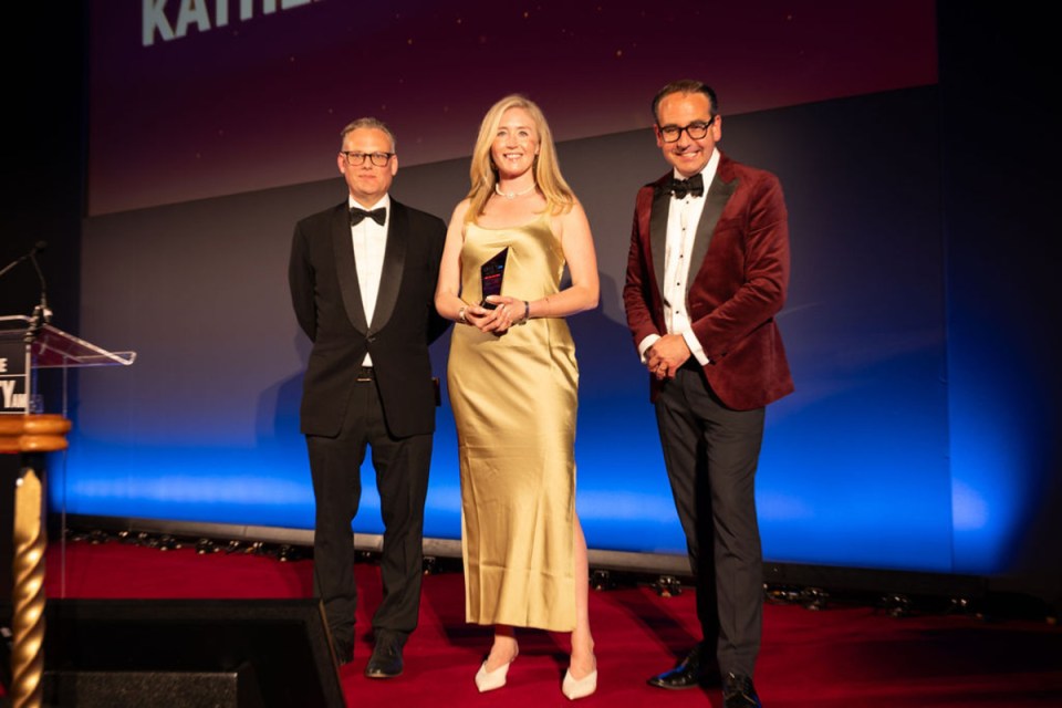 Kathleen Brooks accepting an award at City PM Awards ceremony, celebrating achievements in the business sector.
