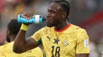 Football players taking a hydration break during a World Cup match, highlighting the divisive pause amid rising temperatures.