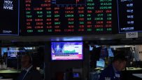 NYSE trading floor bustling with activity as traders monitor market trends and stock performance on electronic displays