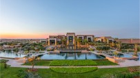 Fairmont Marrakech luxury hotel exterior with lush gardens and elegant architecture under clear blue skies