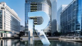 Revolut London office glass facade with prominent R logo reflecting cityscape, highlighting modern fintech design