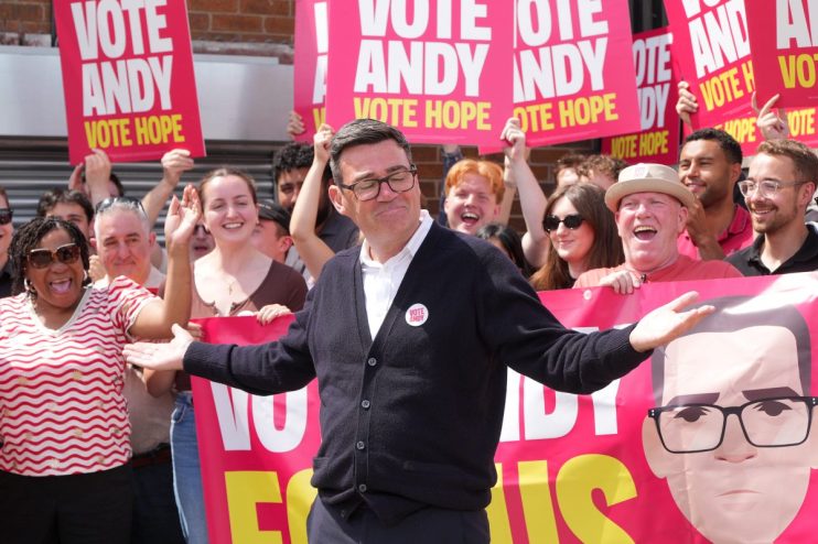 Andy Burnham supporters rallying with banners and signs at a political event, showcasing enthusiasm and solidarity