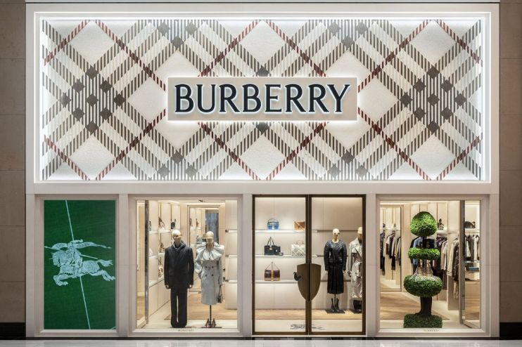 Burberry store facade with classic plaid pattern, logo, display windows featuring mannequins and handbags