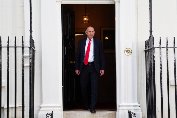 Chancellor John Healey speaking at a professional event, likely a press conference or address.