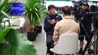 Alex Albon of Williams Racing giving an interview, with a camera crew nearby and Atlassian branding visible.