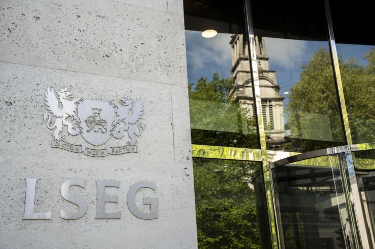 LSEG building entrance with company logo and reflections of a church tower and trees in the glass facade
