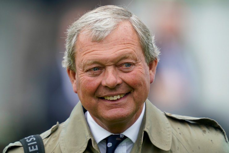 William Haggas, a man with gray hair and blue eyes, smiling and wearing a tan coat and patterned tie