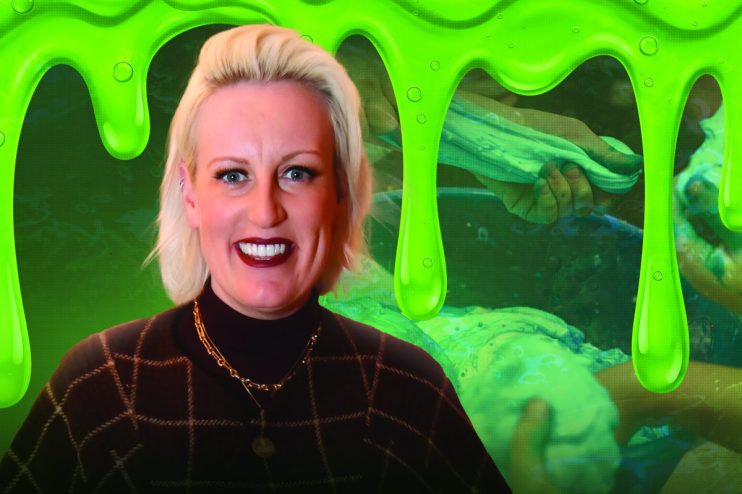 Blonde woman smiling with green slime background, children playing with goo, Gootopia online experience